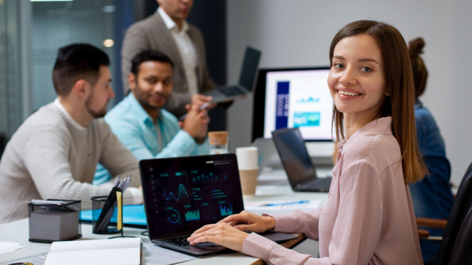 Profissional utilizando notebook com gráficos em ambiente corporativo de tecnologia, representando proteção de propriedade intelectual e segurança de informações estratégicas.